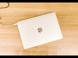 MacBook in flat day photography with white case.